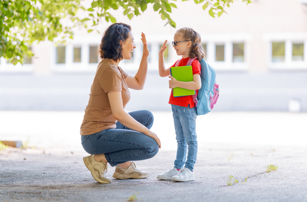 A photo of a mom and her daughter both are smiling and happy. The daughter is going to school.
